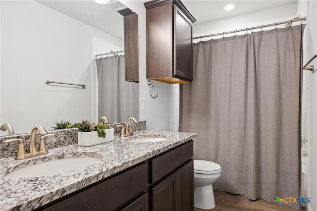2516 Arno St, Harker Heights, TX 76548 - bathroom featuring wood finished floors, double vanity, and a shower with shower curtain