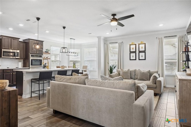 2516 Arno St, Harker Heights, TX 76548 - living room with plenty of natural light, crown molding, a ceiling fan, recessed lighting, and wood finished floors