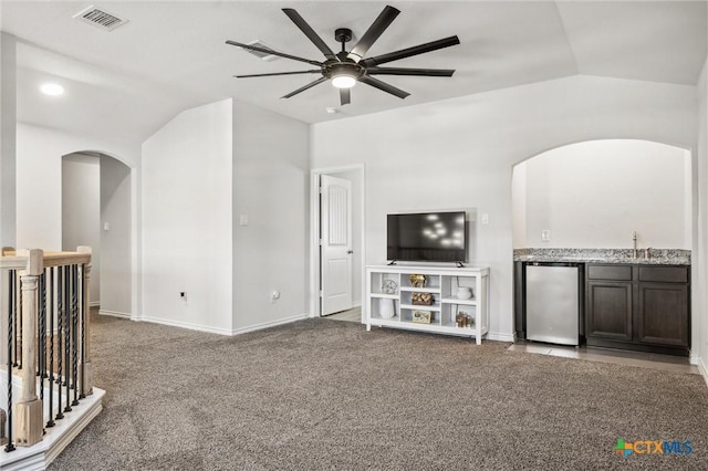 2516 Arno St, Harker Heights, TX 76548 - unfurnished living room featuring arched walkways, ceiling fan, carpet floors, vaulted ceiling, and wet bar