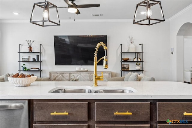 2516 Arno St, Harker Heights, TX 76548 - kitchen with open floor plan, dark brown cabinets, ornamental molding, stainless steel dishwasher, and arched walkways