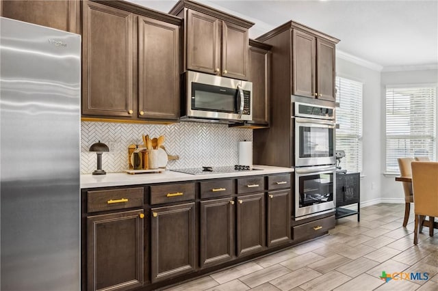 2516 Arno St, Harker Heights, TX 76548 - kitchen with appliances with stainless steel finishes, backsplash, crown molding, light countertops, and dark brown cabinets