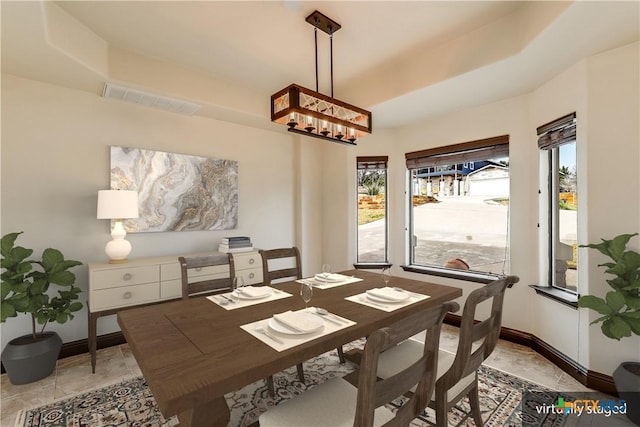 dining area with a tray ceiling