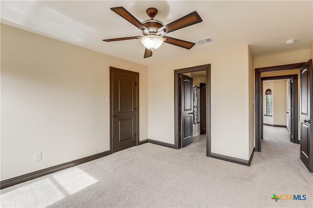 unfurnished bedroom with light carpet and ceiling fan