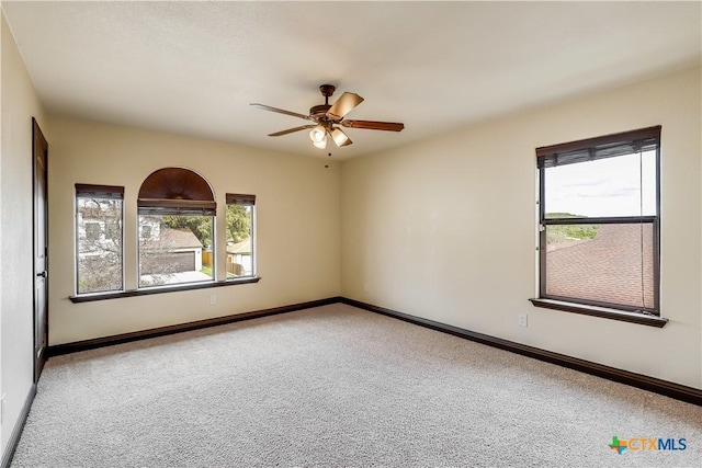 carpeted empty room featuring ceiling fan