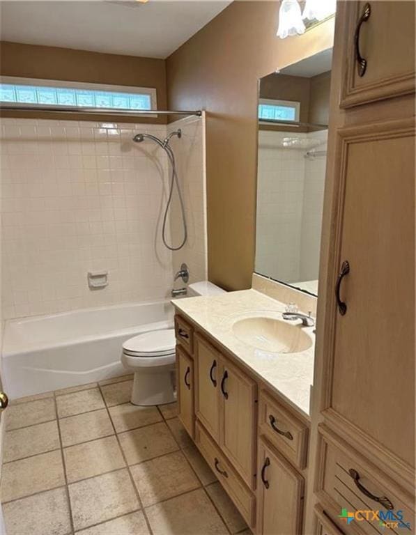 bathroom featuring toilet, tile patterned floors, bathing tub / shower combination, and vanity