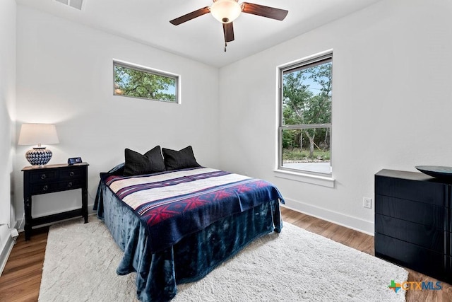 213 Lets Roll Dr, Fischer, TX 78623 - bedroom featuring baseboards, wood finished floors, and ceiling fan