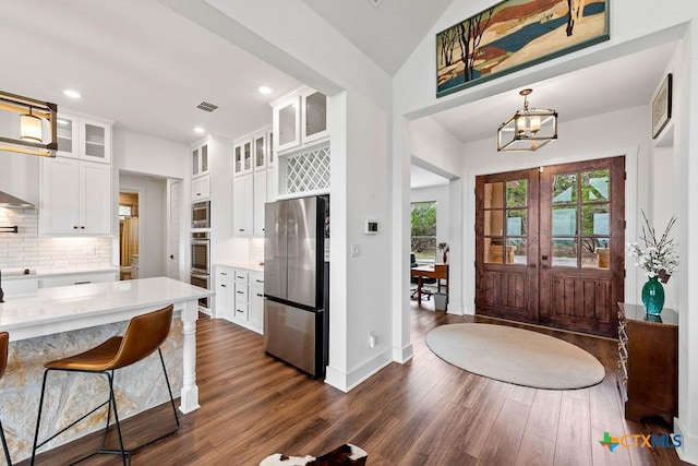 213 Lets Roll Dr, Fischer, TX 78623 - kitchen with stainless steel appliances, dark wood finished floors, backsplash, light countertops, and a chandelier