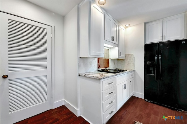 kitchen with black refrigerator with ice dispenser, dark hardwood / wood-style floors, white cabinets, and gas cooktop