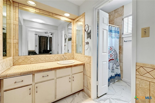 bathroom featuring curtained shower and vanity