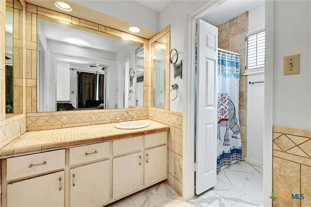 bathroom featuring curtained shower and vanity