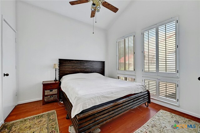 bedroom featuring lofted ceiling, hardwood / wood-style flooring, and ceiling fan