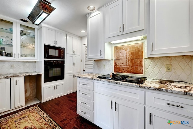 kitchen featuring white cabinets, dark hardwood / wood-style floors, and black appliances