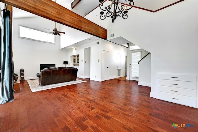 living room featuring hardwood / wood-style floors, ceiling fan with notable chandelier, beamed ceiling, and a high ceiling