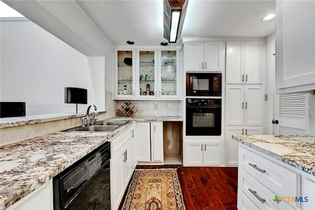 kitchen featuring black appliances, white cabinetry, dark hardwood / wood-style floors, light stone countertops, and sink