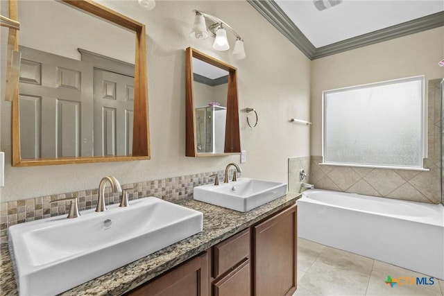 bathroom featuring a bath, tile patterned flooring, ornamental molding, and a sink