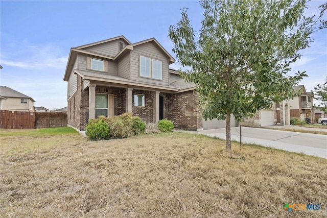 view of front facade featuring driveway, a garage, fence, a front lawn, and brick siding