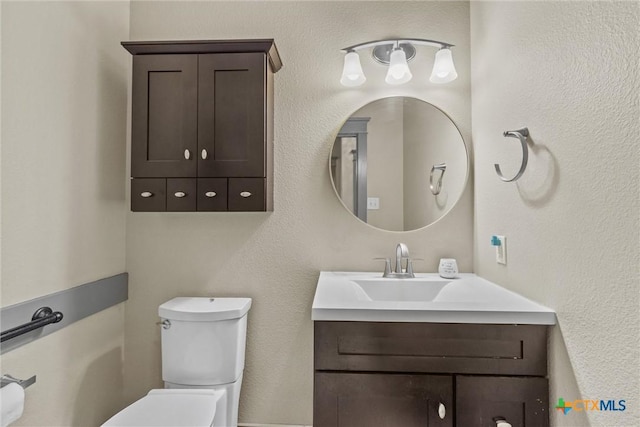 half bathroom with vanity and toilet