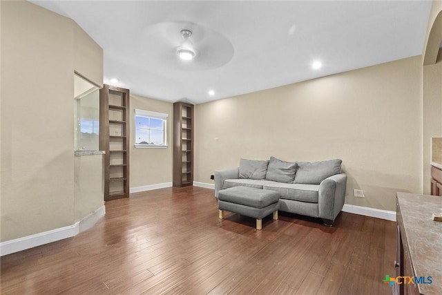 living area with recessed lighting, wood finished floors, and baseboards