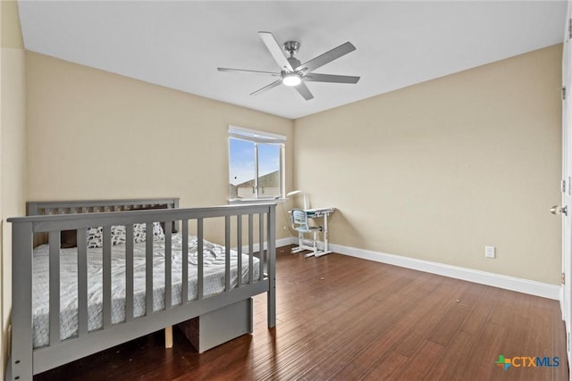 bedroom featuring ceiling fan, baseboards, and wood finished floors