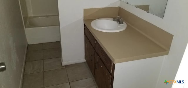 bathroom featuring tile patterned flooring and vanity