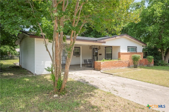 single story home with a front yard and covered porch