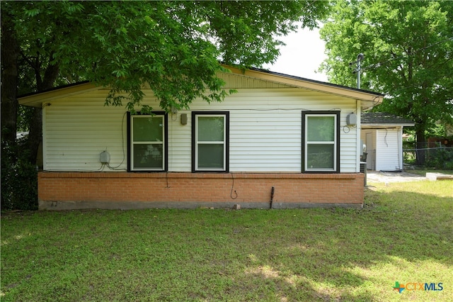 view of side of home with a lawn