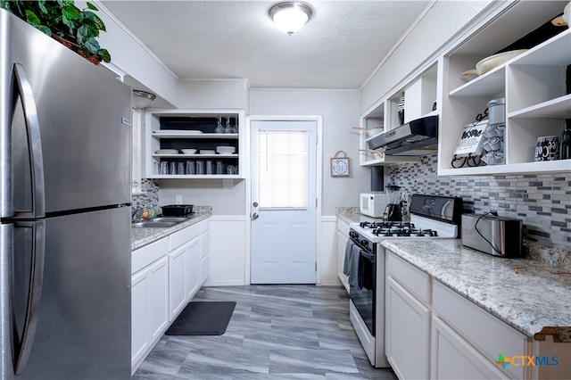 kitchen featuring decorative backsplash, sink, extractor fan, white cabinetry, and white appliances