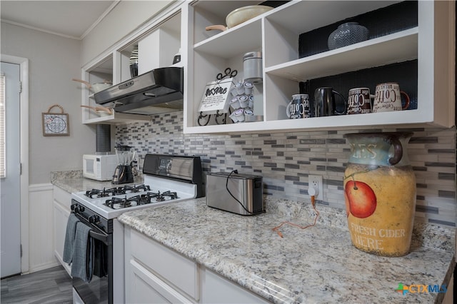 kitchen with white cabinets, exhaust hood, white appliances, and light stone countertops