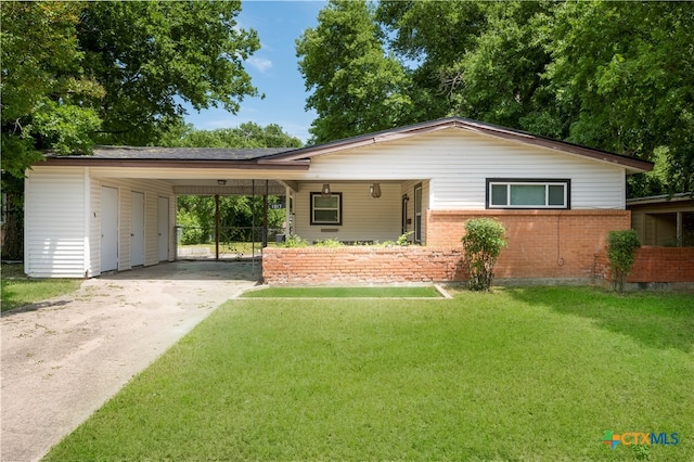 ranch-style house with a carport and a front lawn