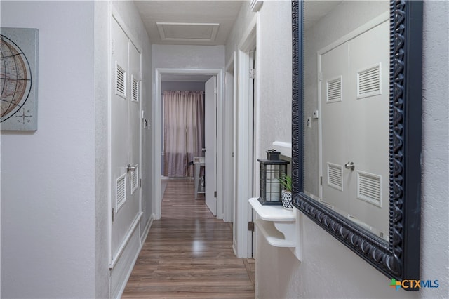 hallway with hardwood / wood-style flooring