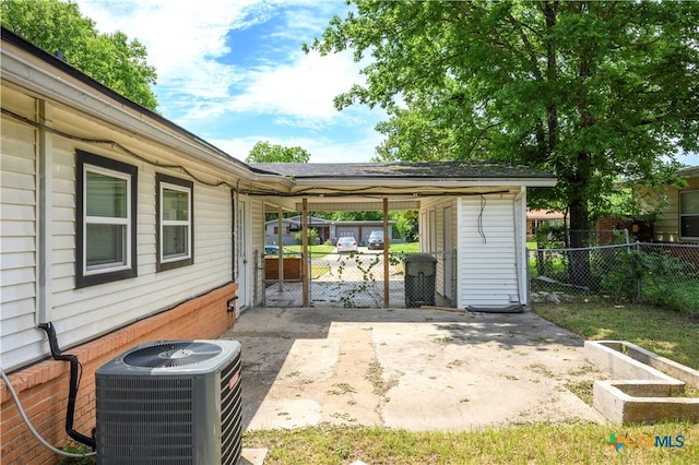 view of patio / terrace with a shed and central air condition unit