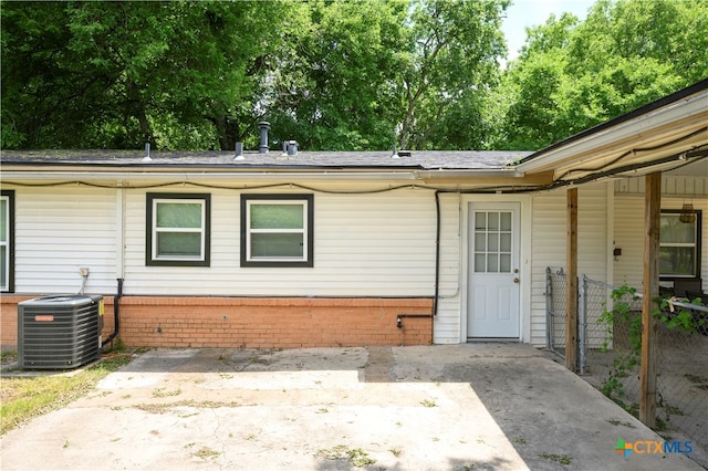 exterior space with central AC unit and a patio area