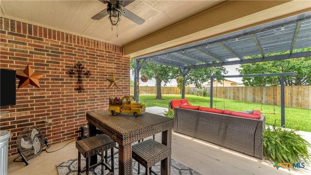 view of patio / terrace with ceiling fan, an outdoor living space, and a pergola