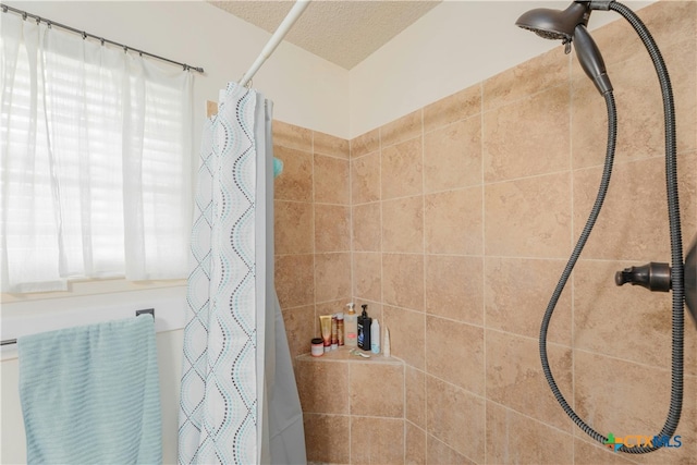 bathroom featuring walk in shower and a textured ceiling