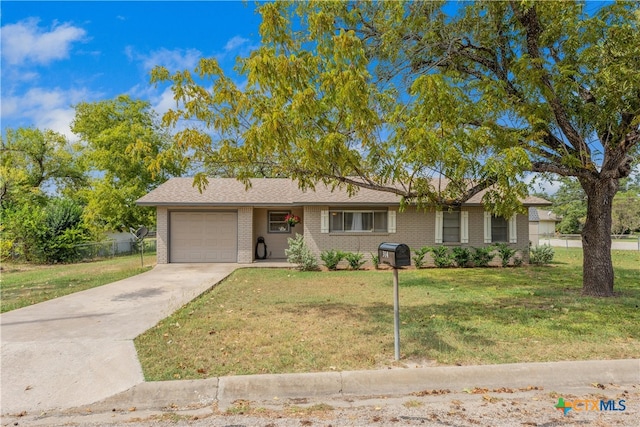 ranch-style house featuring a garage and a front lawn