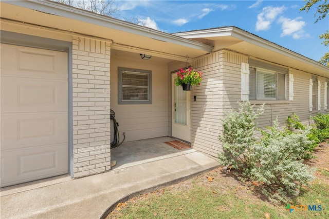 doorway to property with a garage