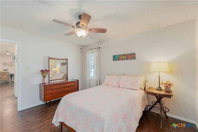 bedroom featuring ceiling fan, a textured ceiling, and dark hardwood / wood-style flooring