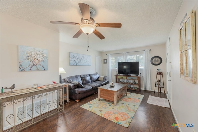 living room featuring dark hardwood / wood-style floors and a textured ceiling