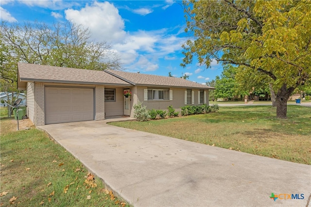 single story home with a garage and a front lawn