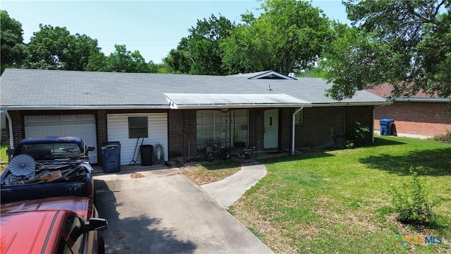 209 Candlelight Ln, Port Lavaca, TX 77979 - ranch-style home featuring an attached garage, a front yard, brick siding, a porch, and driveway