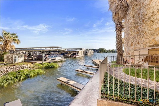 dock area with a water view and boat lift