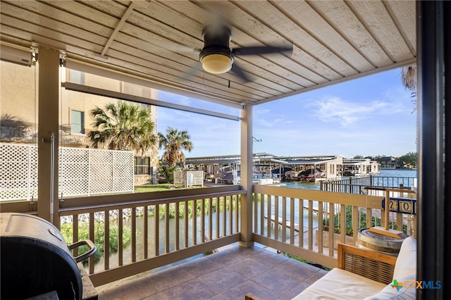 exterior space with a water view and ceiling fan