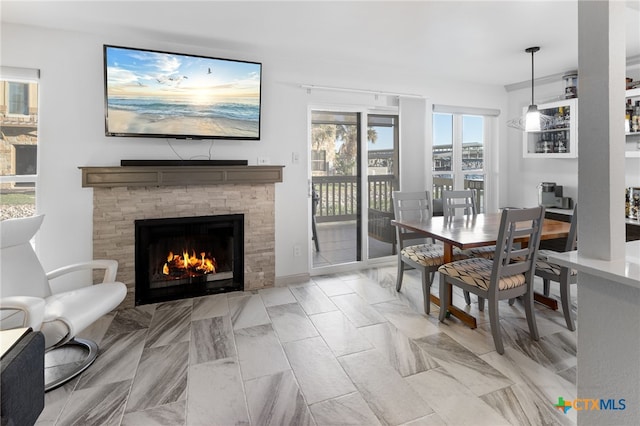 dining space with a fireplace with flush hearth