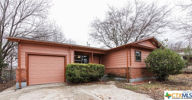 ranch-style home featuring a garage