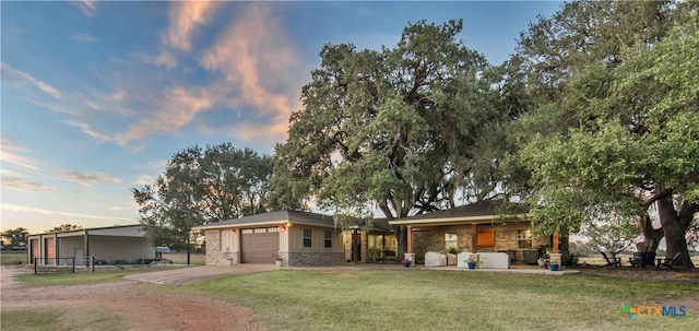 view of front facade with a garage and a yard