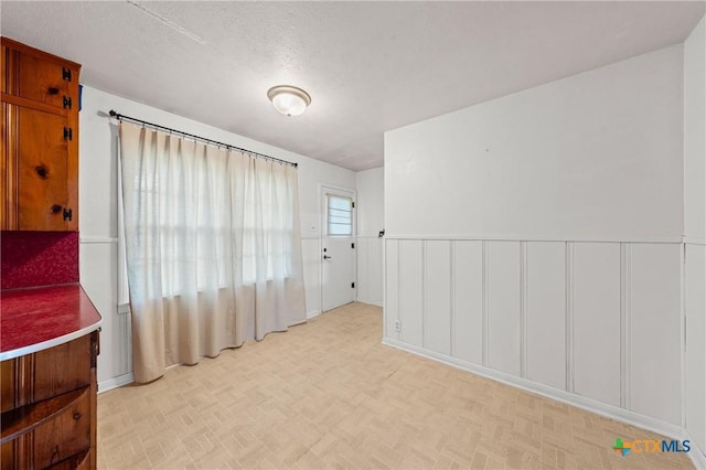 1820 S 49th St, Temple, TX 76504 - empty room featuring a textured ceiling and a wainscoted wall