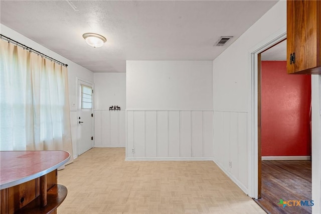 1820 S 49th St, Temple, TX 76504 - unfurnished dining area with a wainscoted wall and a decorative wall