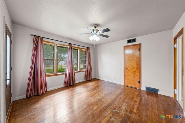 1820 S 49th St, Temple, TX 76504 - unfurnished bedroom featuring wood finished floors, a ceiling fan, and a textured ceiling