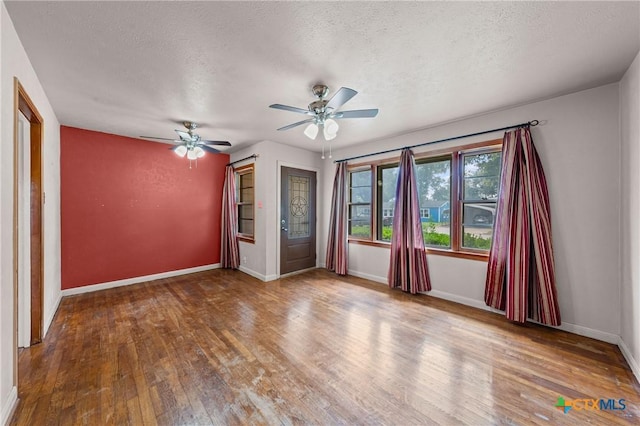 1820 S 49th St, Temple, TX 76504 - unfurnished room with wood finished floors, a ceiling fan, and a textured ceiling