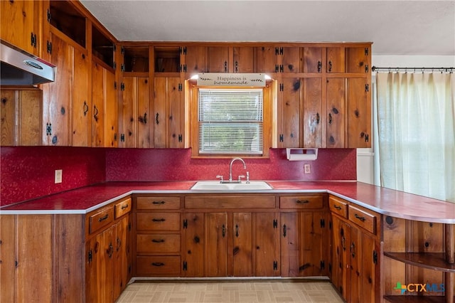 1820 S 49th St, Temple, TX 76504 - kitchen with under cabinet range hood, brown cabinets, and a peninsula